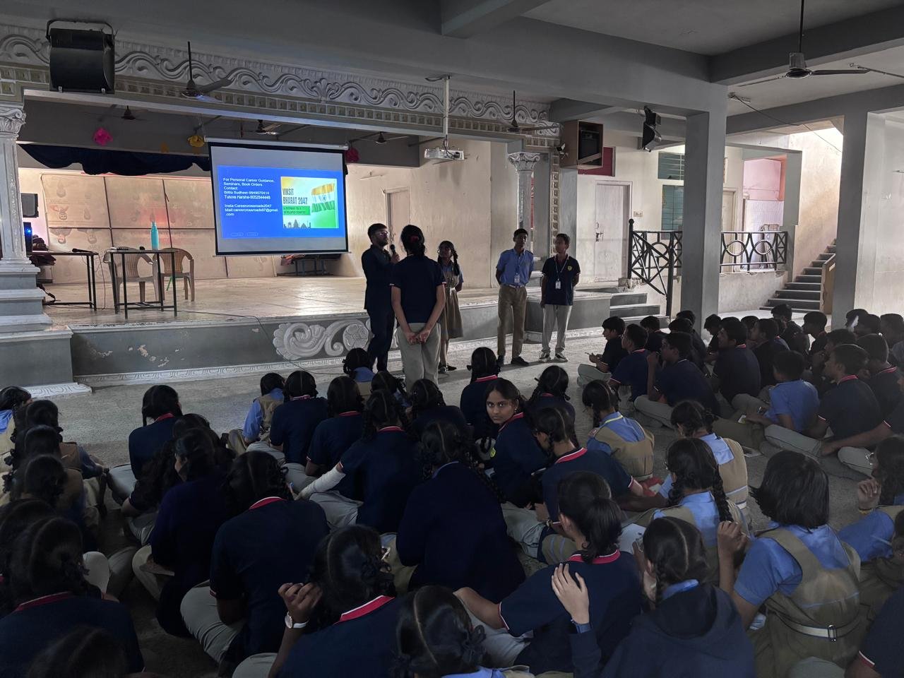 Students joining the presenter on stage